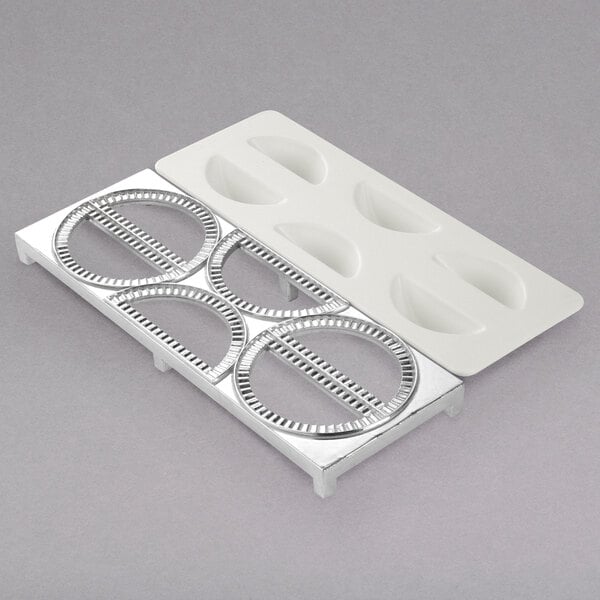 A white plastic tray with two metal rings with circles on it.