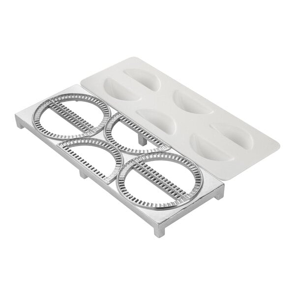 A metal and plastic kitchen tool with four circular molds and a white tray, designed for shaping and pressing dumplings or pierogi.