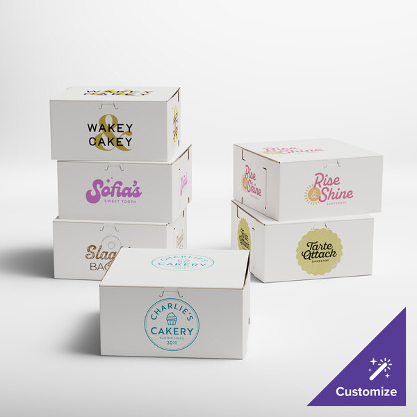 A set of white customizable bakery boxes with various printed logos and designs.