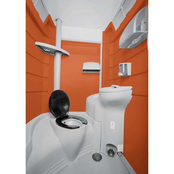 A PolyJohn portable restroom with an orange exterior.