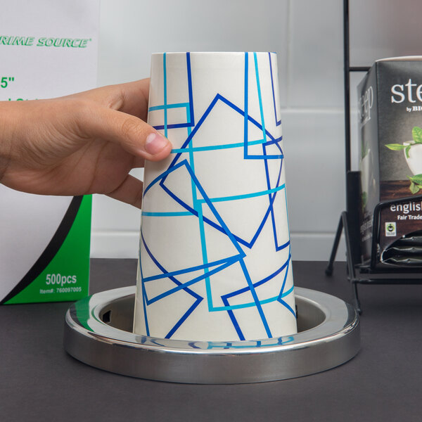 A hand using a San Jamar cup dispenser to get a paper cup.