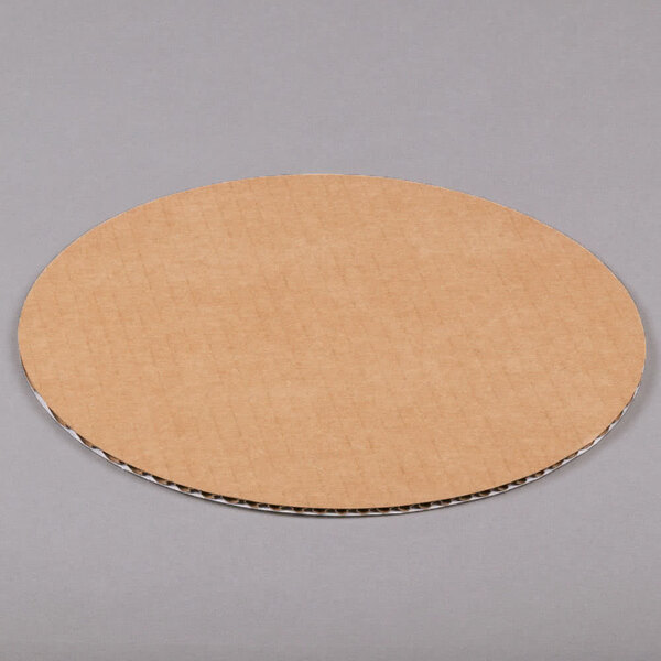 A white corrugated cardboard circle with a grid on it.