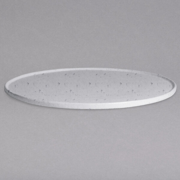 A close-up of a G.E.T. Enterprises Bugambilia marble white metal disc with a rim and holes.