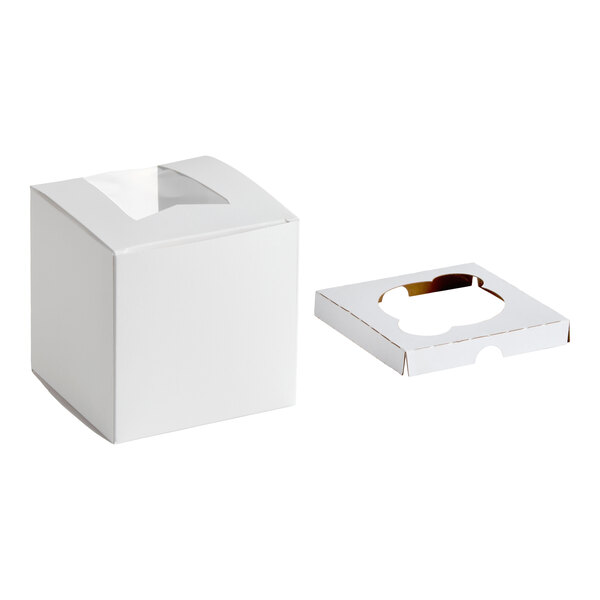 A white square box with a transparent window on top, shown next to a separate insert with a single slot.