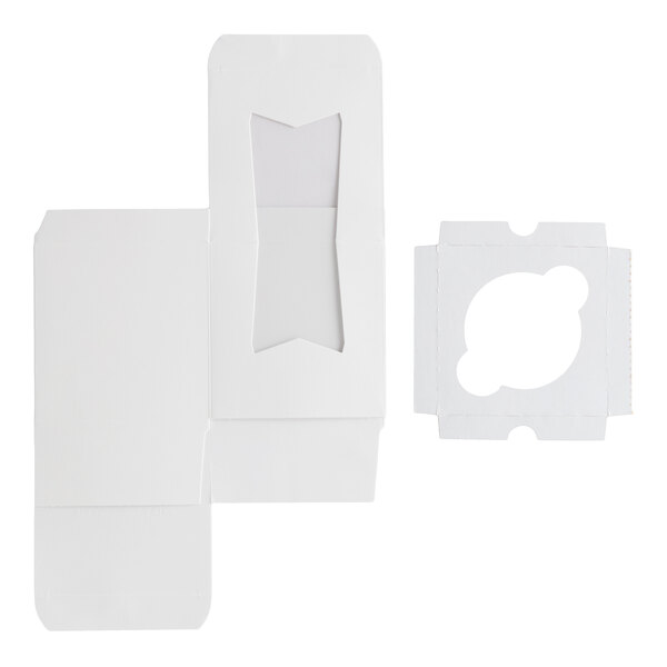 A flat, white cardboard box with a clear window and a separate insert featuring a single circular slot, both shown unfolded.
