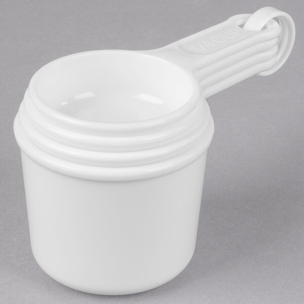 A white Rubbermaid plastic measuring cup with a handle.