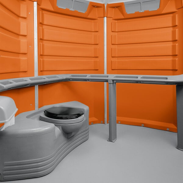 A grey and orange PolyJohn wheelchair accessible portable toilet.
