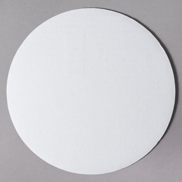 A 10" white corrugated cake circle on a gray surface.
