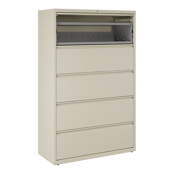 A beige five-drawer lateral file cabinet with a roll-out binder storage compartment at the top.