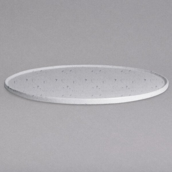 A close-up of a G.E.T. Enterprises marble white granite resin-coated aluminum round platter with a textured finish and rim with holes.