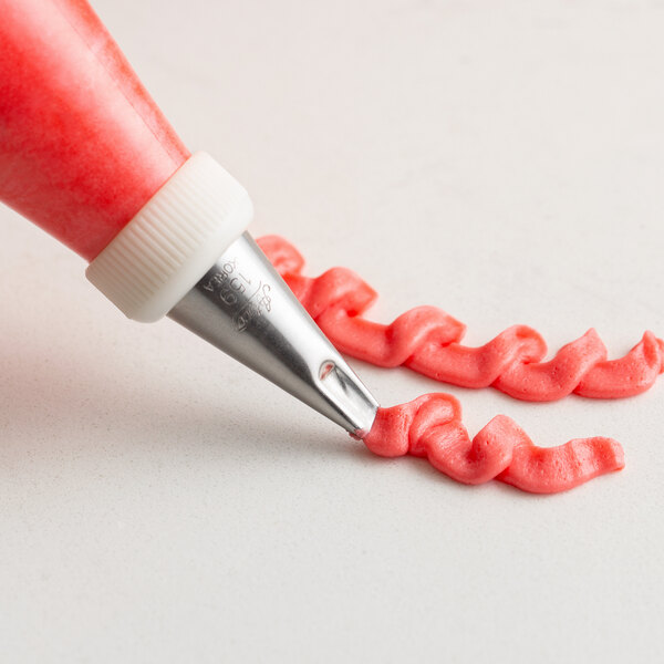 A person using a left-handed curved petal piping tip in a pastry bag to make a ribbon.