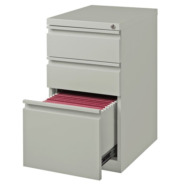 A white file cabinet with red file folders.