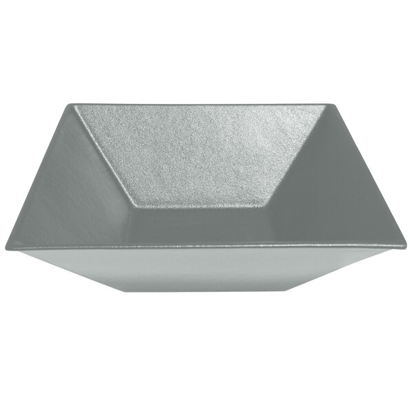 A silver triangular metal bowl with a textured finish.