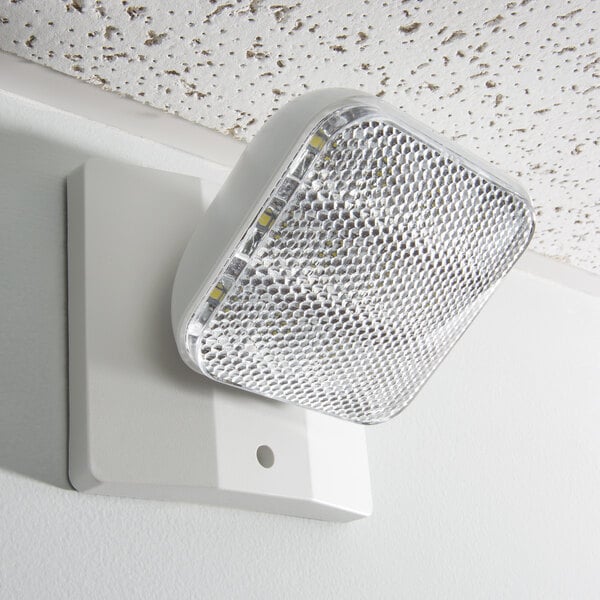 A Lavex indoor emergency light with a white fixture on the wall.