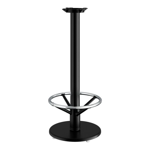 A Lancaster Table & Seating black cast iron bar height table base with a round foot ring.