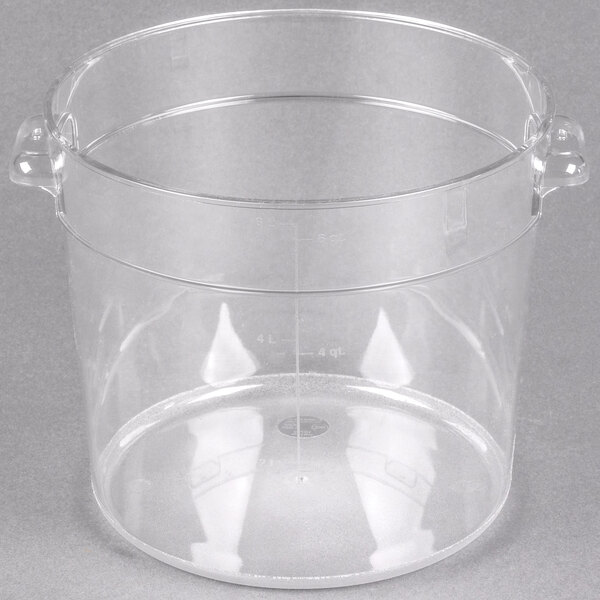 A Carlisle clear plastic food storage container with handles.