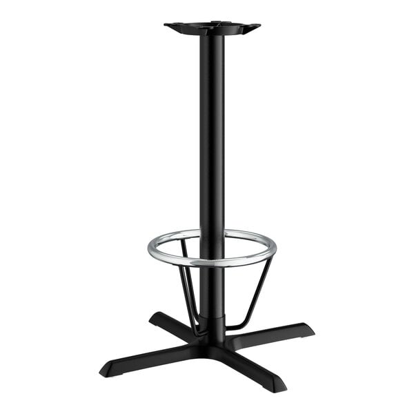 A black cast iron bar height table base with a foot ring.