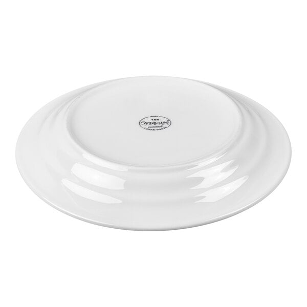 A white porcelain plate shown upside down with a small circular logo or stamp in the center.