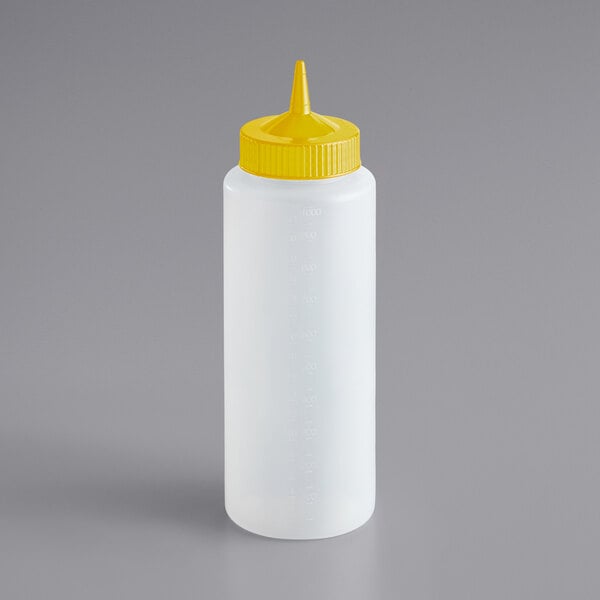 A white bottle with a yellow lid.