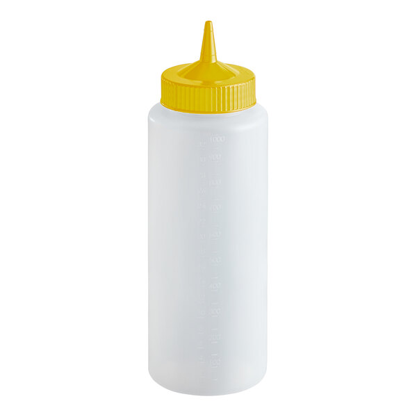 A clear 32 oz. squeeze bottle with a yellow single tip cap.