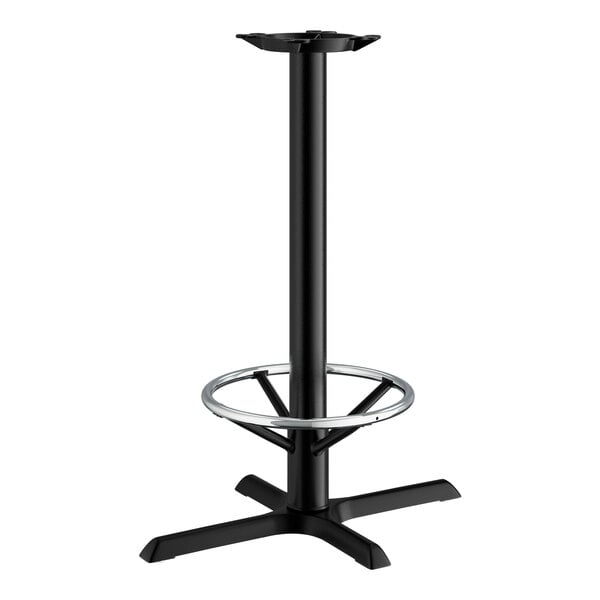 A Lancaster Table & Seating black cast iron bar height table base with a round foot ring.