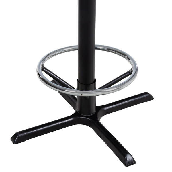 Silver foot ring around black steel cross table base