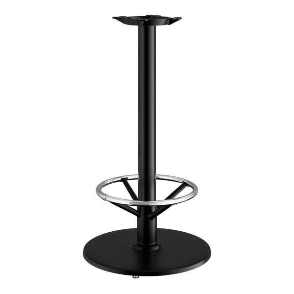 A Lancaster Table & Seating black cast iron bar height table base with a round metal foot ring.