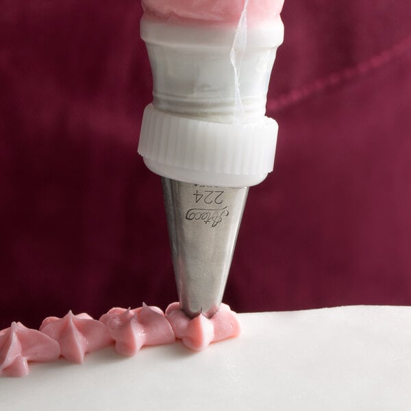 A white cake decorated with an Ateco drop flower pastry tip.