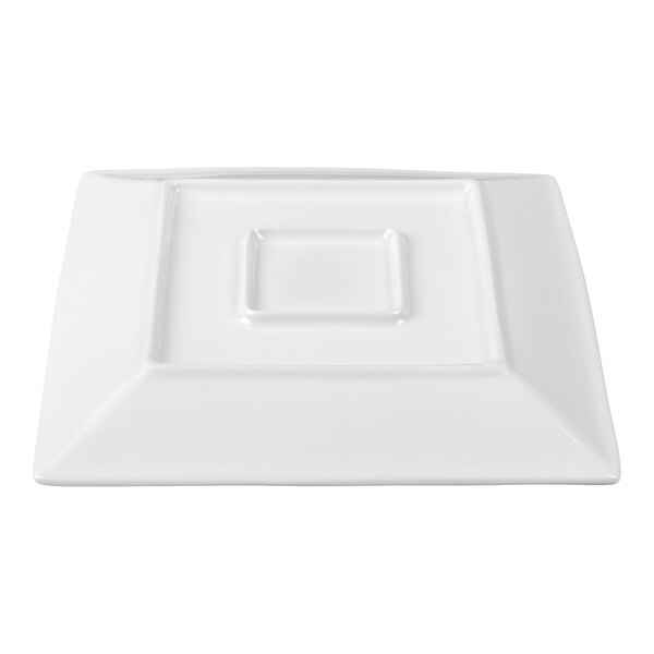 A white, square porcelain plate with a raised geometric design in the center.