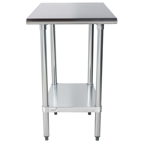 An Advance Tabco stainless steel work table with a galvanized undershelf.