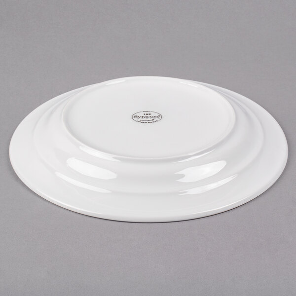 A white Libbey porcelain plate with a circular design on it.