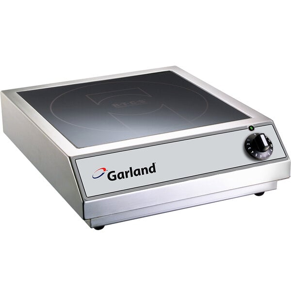 A close-up of a Garland countertop induction range on a counter.