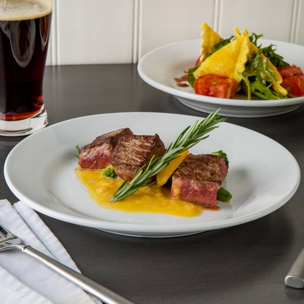 A white Libbey Rigel Constellation porcelain plate with food and a drink on a table.