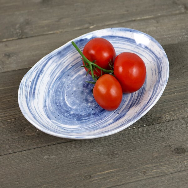 a plate of tomatoes on a wood surface