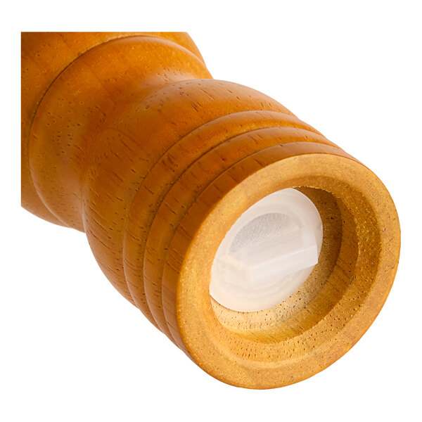 A close-up of a wooden Acopa salt shaker with a white cap.