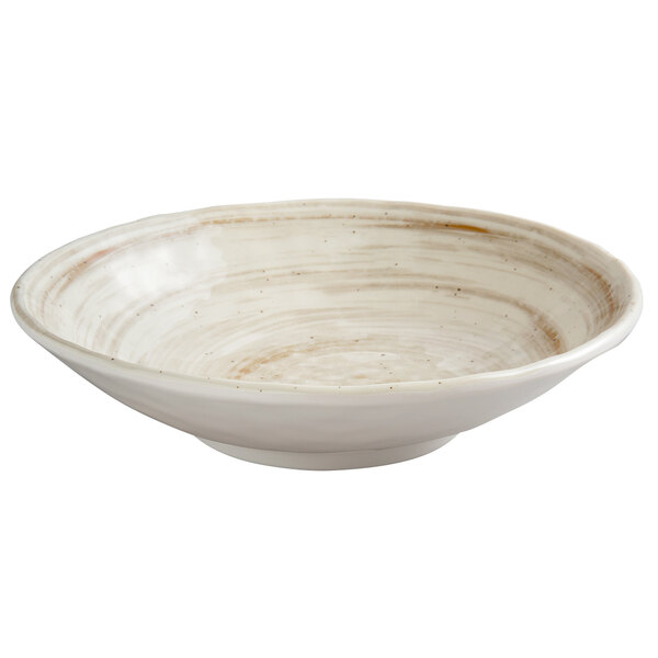 a white bowl with brown specks