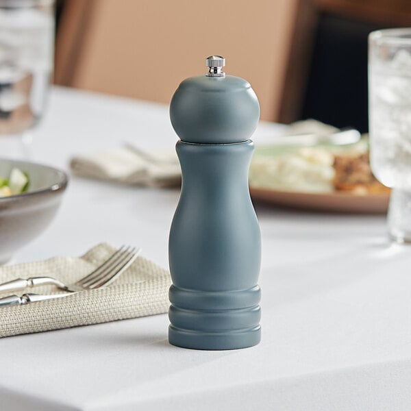 An Acopa wooden salt and pepper mill on a table.