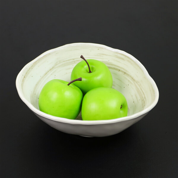 An Elite Global Solutions taupe melamine bowl filled with green apples.