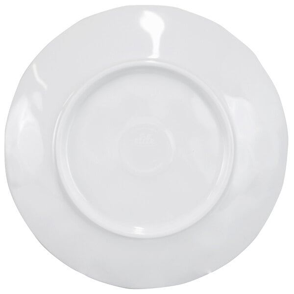 A white round melamine plate with a wavy navy rim.