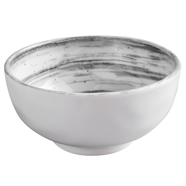 a white bowl with black specks