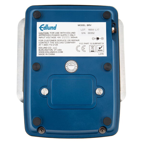 A blue rectangular Edlund BRAVO! digital meter with white text on the back.