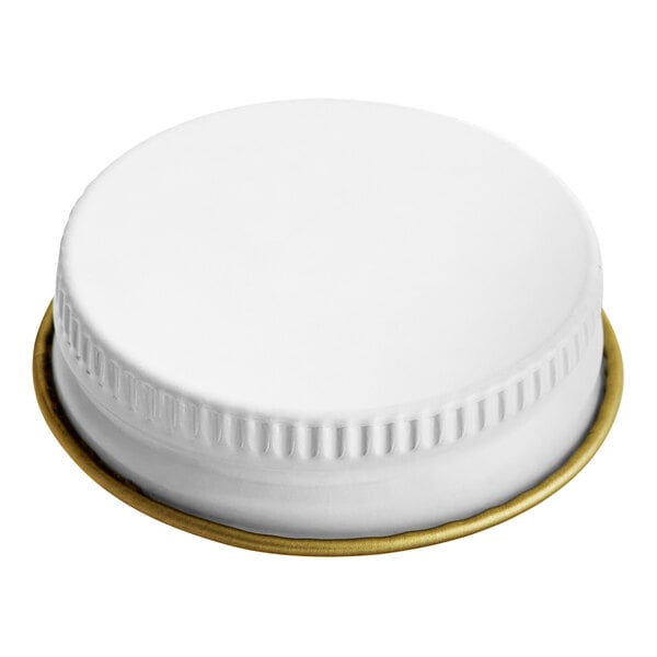 A white plastic Libbey growler cap with a gold rim.