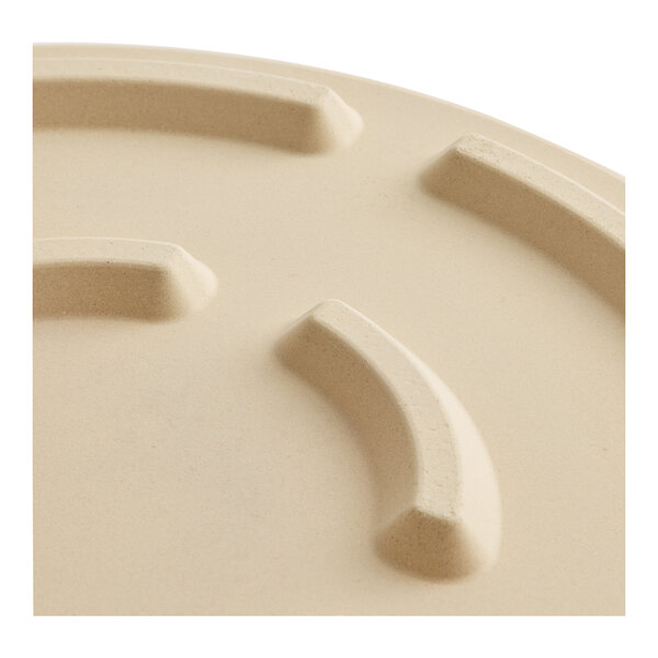 An American Metalcraft round cordierite pizza stone on a white surface.