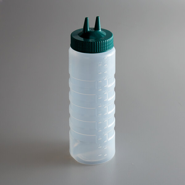 A clear plastic Vollrath Twin Tip squeeze bottle with a green cap with two pointy tips.