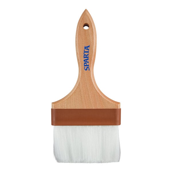 A wide brush with white bristles, a wooden handle, and a brown band near the bristles.