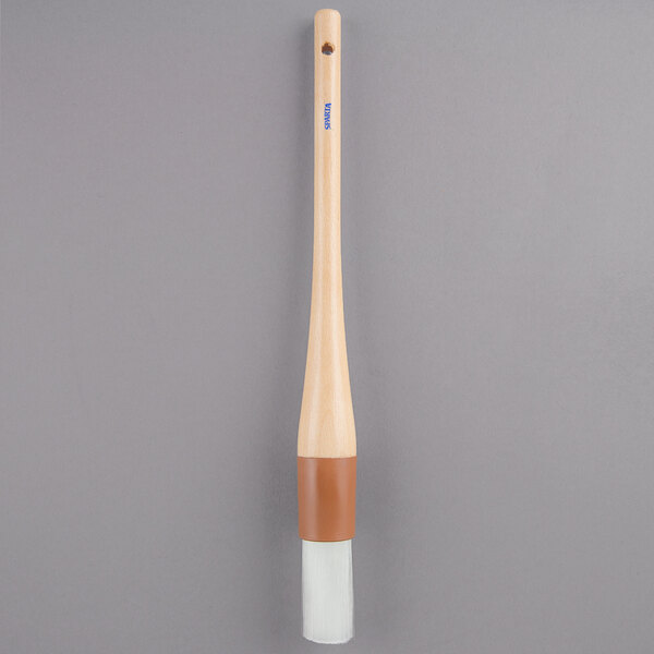 A Carlisle Sparta Spectrum pastry brush with a white handle.