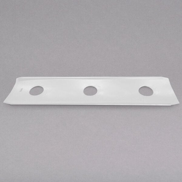 A white rectangular plastic object with holes in it.