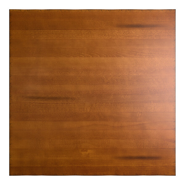 A square wooden surface with a warm, rustic walnut finish and subtle wood grain patterns.