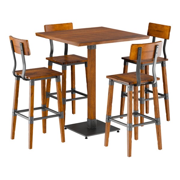 A Lancaster Table & Seating square table with a live edge and four bar stools with metal legs.