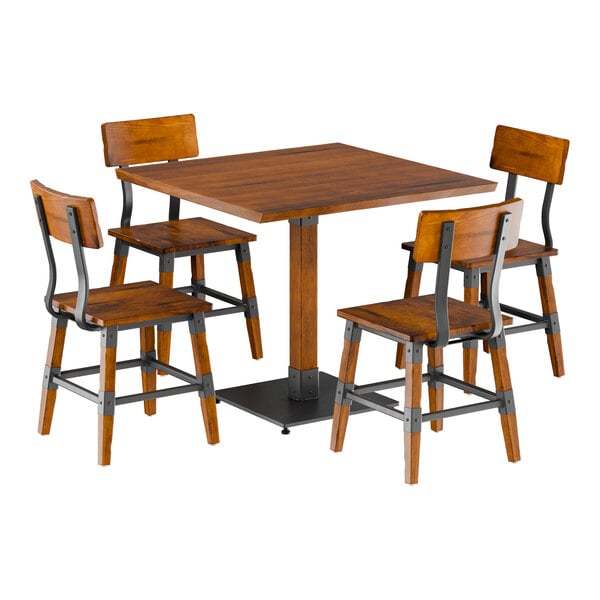 A Lancaster Table & Seating live edge wooden table with metal legs and four wooden chairs.